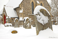 Snow-Covered Gravestone and Church