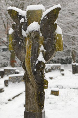 Snow-Covered Gravestone Statue